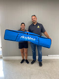 SkyVac customer husband and wife holding their pole bag