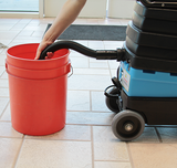 Recovery tank drain hose for the Mytee Lite with bucket in use